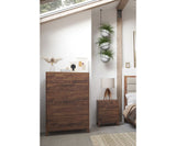 Wooden dresser in a bedroom setting with plants and decor.